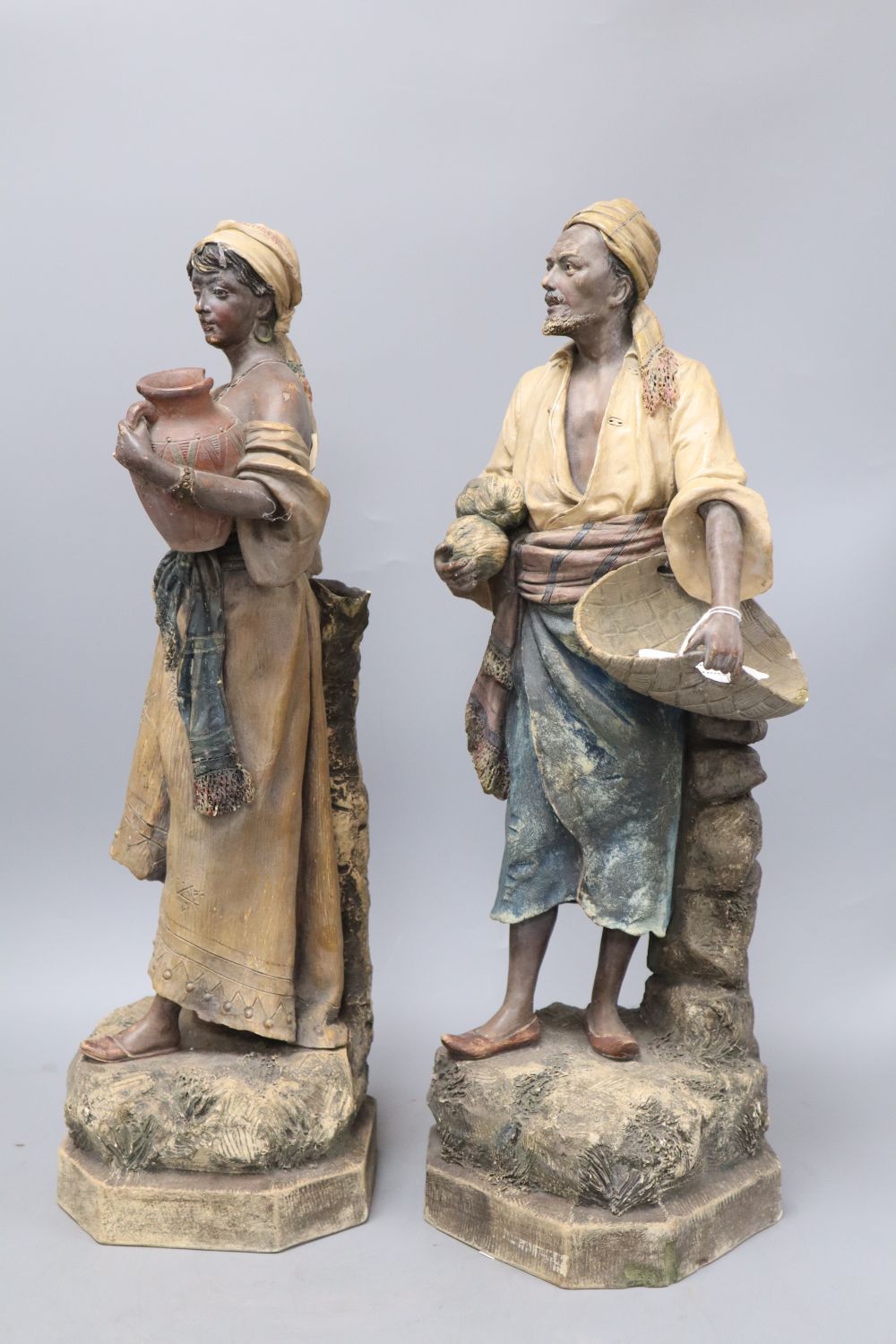 A pair of Austrian earthenware figures of street vendors, by Johann Maresch, height 48cm